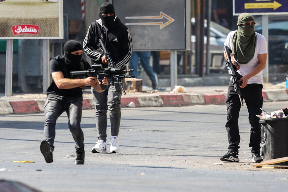Palestinian terrorists during a fight with the IDF in Jenin on July 3, 2023. *Jaafar Ashtiyeh/AFP via Getty Images*. Palestinian armed militants take up position during a confrontation with Israeli army in the occupied West Bank city of Jenin on July 3, 2023. The Israeli army said it had launched drone strikes in Jenin as part of an “extensive counterterrorism effort” that the Palestinian health ministry said killed four residents. (Photo by Jaafar ASHTIYEH / AFP) (Photo by JAAFAR ASHTIYEH/AFP via Getty Images)