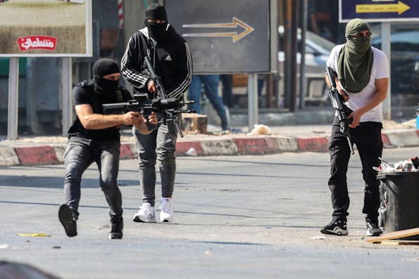 Palestinian armed militants take up position during a confrontation with Israeli army in the occupied West Bank city of Jenin on July 3, 2023. The Israeli army said it had launched drone strikes in Jenin as part of an “extensive counterterrorism effort” that the Palestinian health ministry said killed four residents. (Photo by Jaafar ASHTIYEH / AFP) (Photo by JAAFAR ASHTIYEH/AFP via Getty Images)