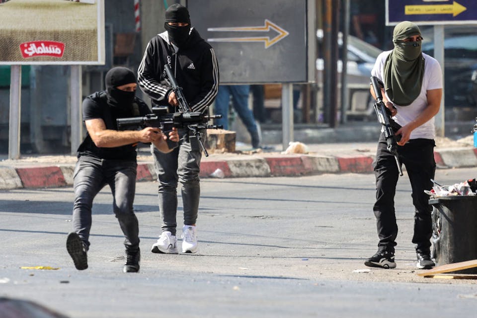 Palestinian armed militants take up position during a confrontation with Israeli army in the occupied West Bank city of Jenin on July 3, 2023. The Israeli army said it had launched drone strikes in Jenin as part of an “extensive counterterrorism effort” that the Palestinian health ministry said killed four residents. (Photo by Jaafar ASHTIYEH / AFP) (Photo by JAAFAR ASHTIYEH/AFP via Getty Images)