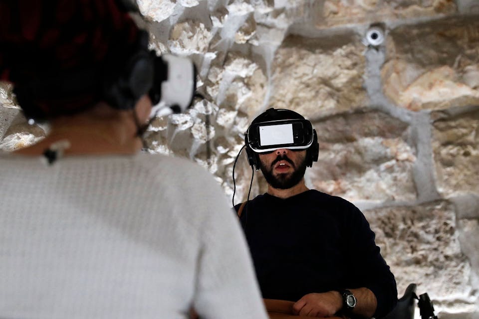 A virtual reality tour of the Second Temple at a visitors center by the Western Wall in Jerusalem on February 23, 2017. *THOMAS COEX / AFP) (Photo by THOMAS COEX/AFP via Getty Images.* Koppel AI LW