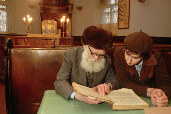 *Two men in Moscow’s main synagogue read a book together in 1987.* Peter Turnley/Corbis/VCG via Getty Images. Grinberg Dostoevsky