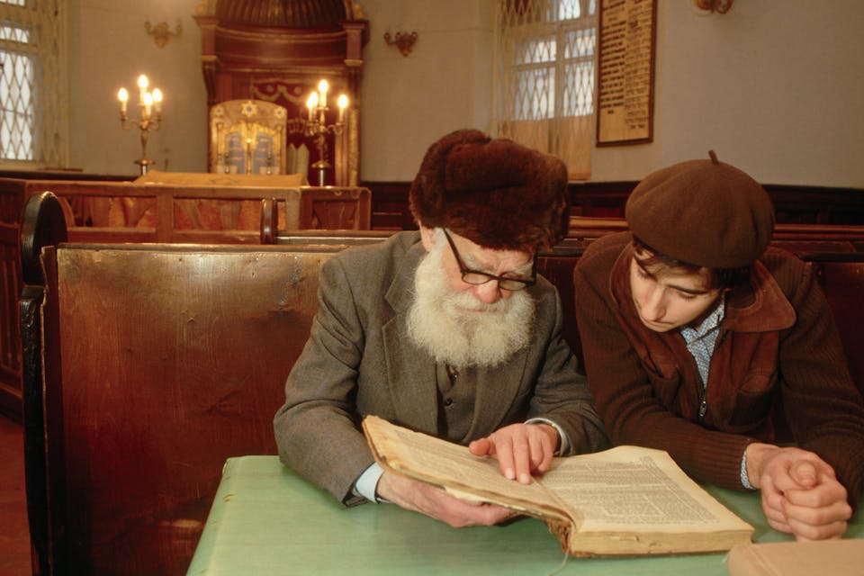 *Two men in Moscow’s main synagogue read a book together in 1987.* Peter Turnley/Corbis/VCG via Getty Images. Grinberg Dostoevsky