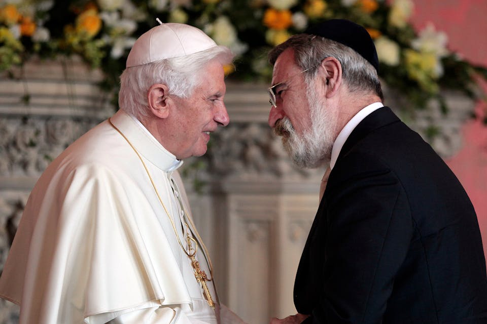 Pope Benedict XVI shakes hands with the UK’s chief rabbi Jonathan Sacks at St. Mary’s University College on September 17, 2010 in Twickenham, England. *Pool/Anwar Hussein Collection/Getty Images.* A Doran Main