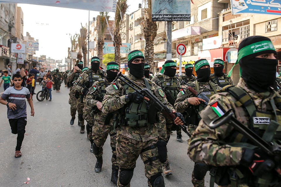 Terrorists from the Al-Qassam Brigades, a military wing of Hamas, marching in Gaza on May 28, 2021. *Sameh Rahmi/NurPhoto via Getty Images*. Greer Main