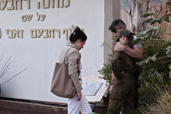 An Israeli soldier hugs her parents before returning to military service on October 15, 2023. *THOMAS COEX/AFP via Getty Images*. Rindner Gaza Main