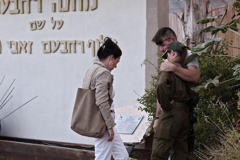 An Israeli soldier hugs her parents before returning to military service on October 15, 2023. *THOMAS COEX/AFP via Getty Images*. Rindner Gaza Main