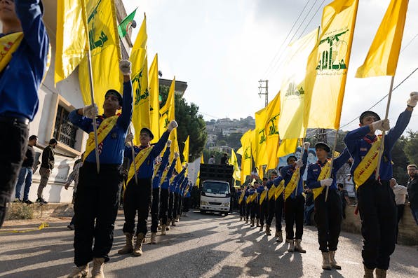 Scouts carrying Hezbollah flags while marching at a funeral for two Hezbollah soldiers killed by the IDF on October 10, 2023 in Khirbet Selm, Lebanon. *Daniel Carde/Getty Images*. Maclean Gaza Main