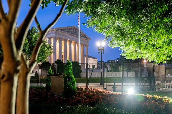 Temporary security fencing surrounds the Supreme Court in Washington, D.C., on June 21, 2022. *STEFANI REYNOLDS/AFP via Getty Images.* White LW