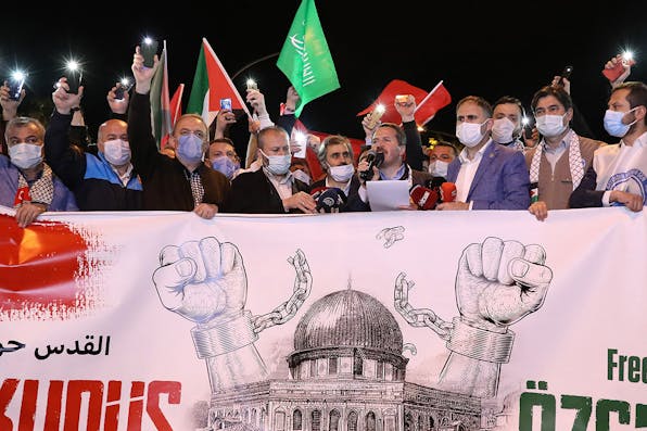 Protesters hold Palestinian and Turkish flags and chant slogans during a demonstration outside the Israeli consulate in Istanbul on May 10, 2021. *ADEM ALTAN/AFP via Getty Images.* Turkey Schanzer