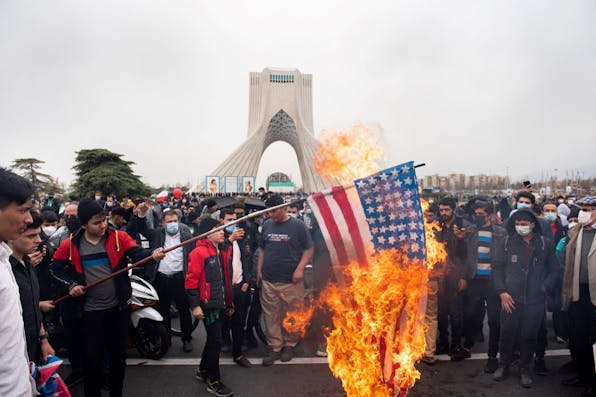 Iranians burn the American flag during a rally to commemorate the 43rd anniversary of the Islamic Revolution on February 22, 2022. *Photo by Sobhan Farajvan/Pacific Press/LightRocket via Getty Images.* Maghen-Doran-Main