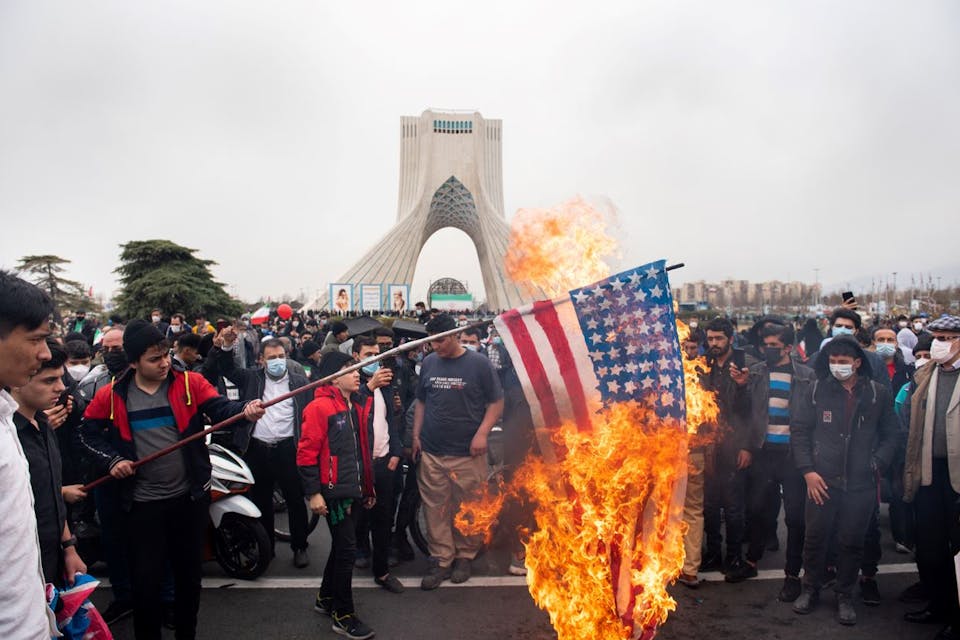 Iranians burn the American flag during a rally to commemorate the 43rd anniversary of the Islamic Revolution on February 22, 2022. *Photo by Sobhan Farajvan/Pacific Press/LightRocket via Getty Images.* Maghen-Doran-Main