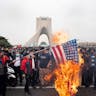 Iranians burn the American flag during a rally to commemorate the 43rd anniversary of the Islamic Revolution on February 22, 2022. *Photo by Sobhan Farajvan/Pacific Press/LightRocket via Getty Images.* Maghen-Doran-Main