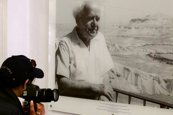 A tourist looking at a picture of David Ben-Gurion at the Independence Hall Museum, the house in Tel Aviv where Ben-Gurion declared Israel’s independence on May, 14 1948. *JACK GUEZ/AFP via Getty Images.* Kramer Declaration EK YG Main