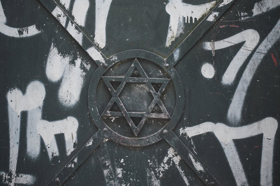 The Star of David surrounded by graffiti on an iron door in Krakow on April 8, 2020. *Artur Widak/NurPhoto via Getty Images*. Cohen IHRA