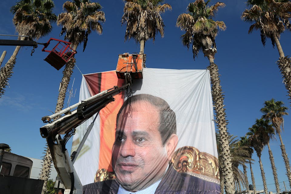 Gazans hang a poster depicting Egypt’s president Abdel Fattah al-Sisi at the Rafah border crossing with Egypt in November 2017. *Majdi Fathi/NurPhoto via Getty Images.* Haissanen Main