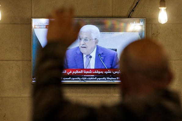 A Palestinian in a coffee shop in Hebron on April 29, 2021 watches a speech by president Mahmoud Abbas. *HAZEM BADER/AFP via Getty Images.* Abrams Gaza Main