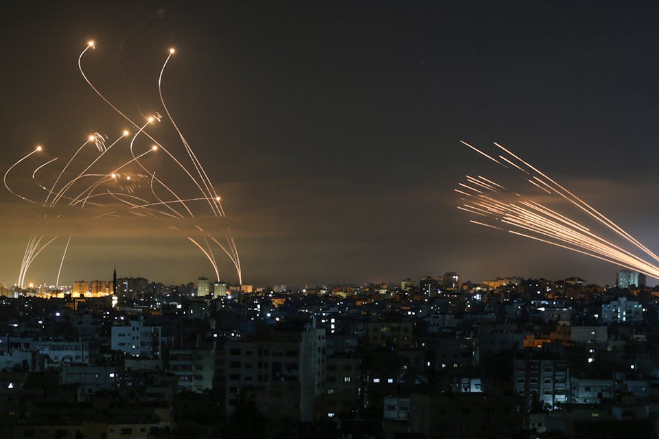 Streaks of light appear as Israel’s Iron Dome anti-missile system intercepts rockets launched from the Gaza Strip on May 16, 2021. *ANAS BABA/AFP via Getty Images.* Main Gaza