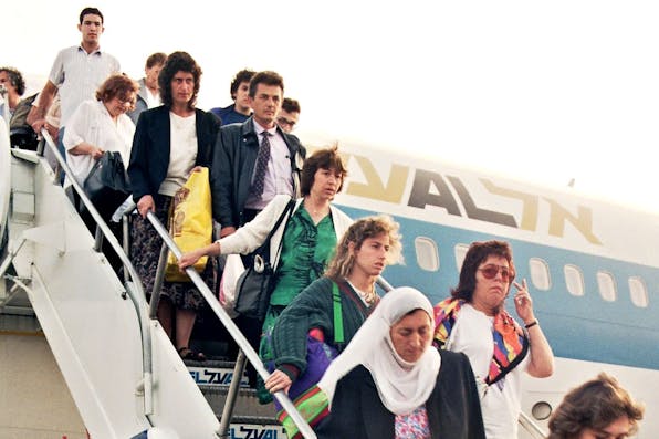 Soviet Jews from Moscow disembark at Ben-Gurion Airport on August 20, 1991. *SVEN NACKSTRAND/AFP via Getty Images.* YKH RUSSIANS