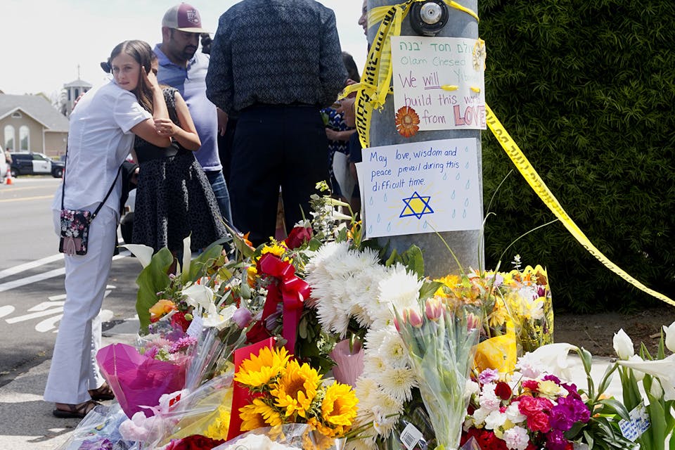 Mourners and well wishers leave flowers and signs at a memorial across the street from the Chabad of Poway Synagogue on Sunday, April 28, 2019 in Poway, California, one day after a teenage gunman opened fire, killing one person and injuring three others. *SANDY HUFFAKER/AFP via Getty Images*. Weiss Response Main