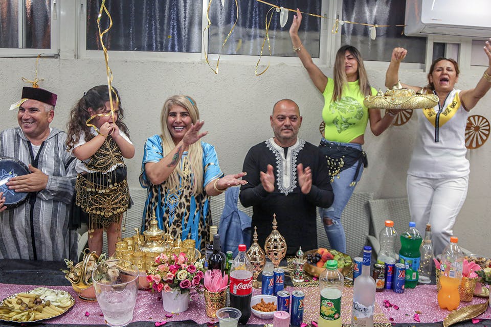 A family celebrating the North African Jewish holiday of Mimouna in the southern Israeli city of Ashkelon on April 15, 2020. *Edi Israel/Flash90*. Mimouna Main