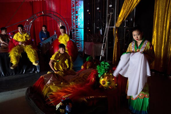 *Chinese circus acrobats wait backstage prior to their performance in the Israeli city of Haifa on March 29, 2016.* MENAHEM KAHANA/AFP/Getty Images. Herman China LW