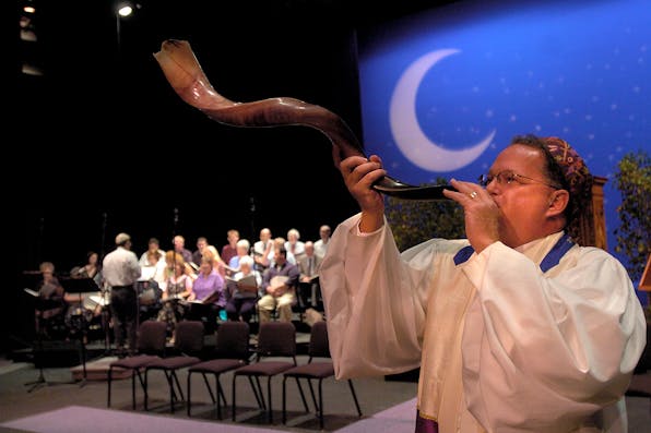 *A rabbi practices blowing the shofar before the start of Rosh Hashanah services.* Getty. Cosgrove Main