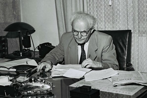 *David Ben-Gurion in his Tel Aviv office on September 1, 1949 in Tel Aviv. The model of a tank on his desk is a cigarette box and lighter given to him by an Israeli soldier.* GPO via Getty Images. BG Tank Desk