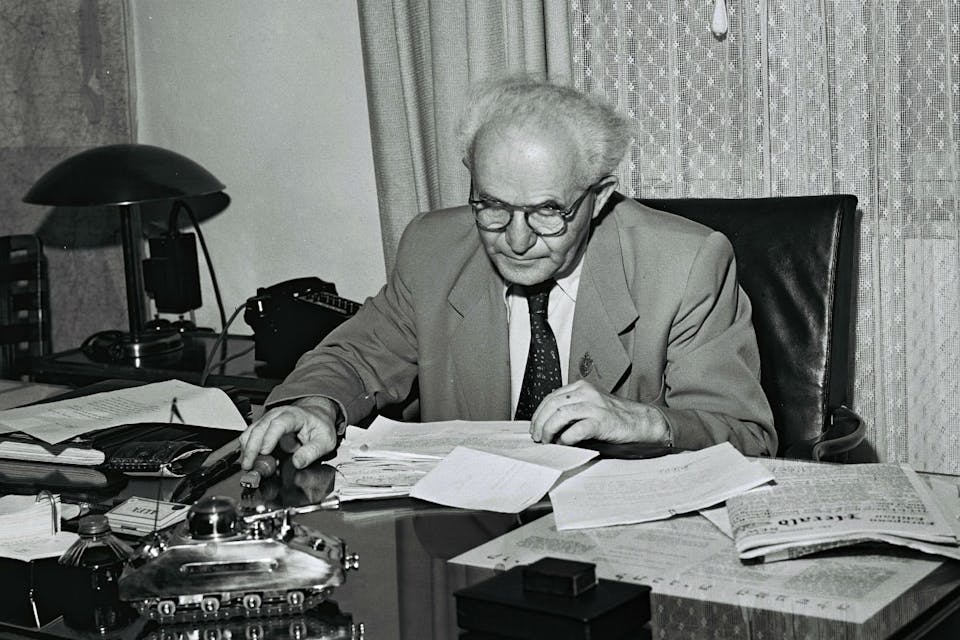 *David Ben-Gurion in his Tel Aviv office on September 1, 1949 in Tel Aviv. The model of a tank on his desk is a cigarette box and lighter given to him by an Israeli soldier.* GPO via Getty Images. BG Tank Desk