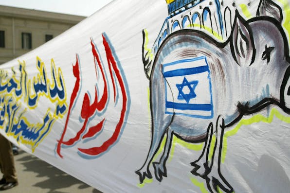 *A huge Arabic banner reading “Today the Israeli pig will desecrate the al-Aqsa mosque” during a 2005 demonstration in Cairo.* AFP/Getty Images. Egypt Israel Protest