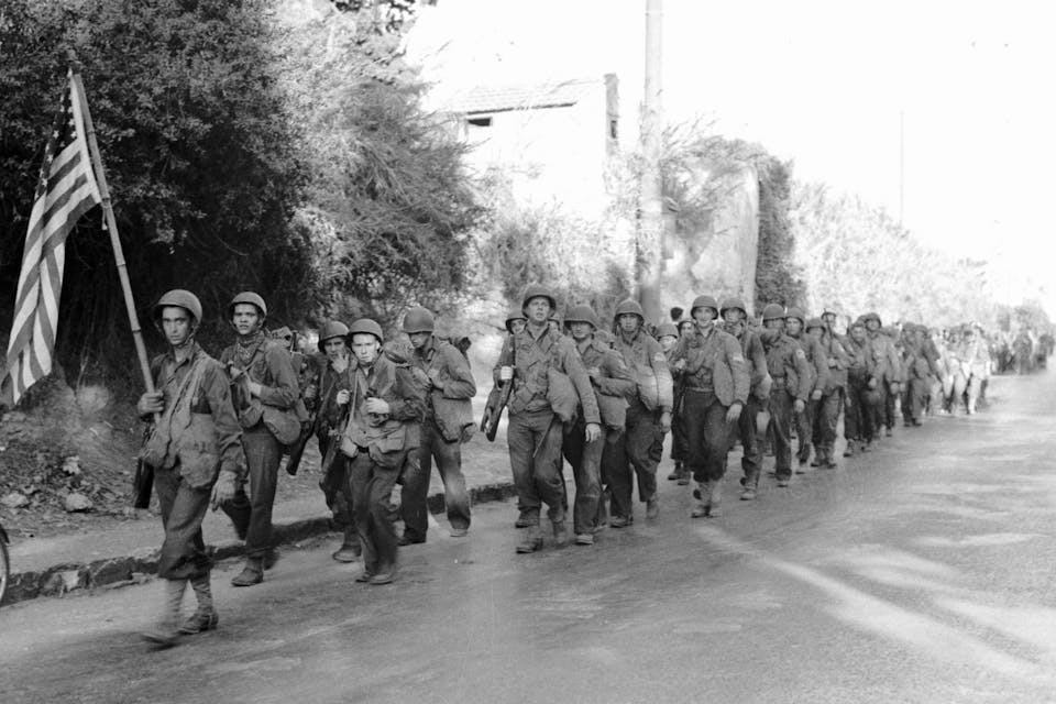 *American infantry marching through Algiers after landing during Operation Torch in 1942.* Bettmann. D PJ North Africa