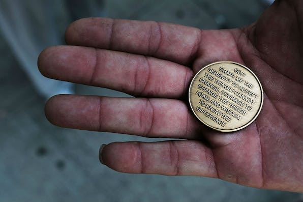 *A patient at a Brooklyn methadone clinic holds a coin with the Serenity Prayer on it*. Spencer Platt/Getty Images. Bloom LW