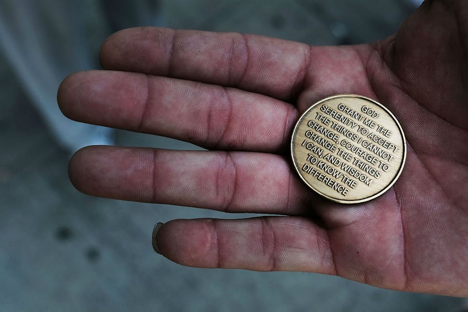 *A patient at a Brooklyn methadone clinic holds a coin with the Serenity Prayer on it*. Spencer Platt/Getty Images. Bloom LW
