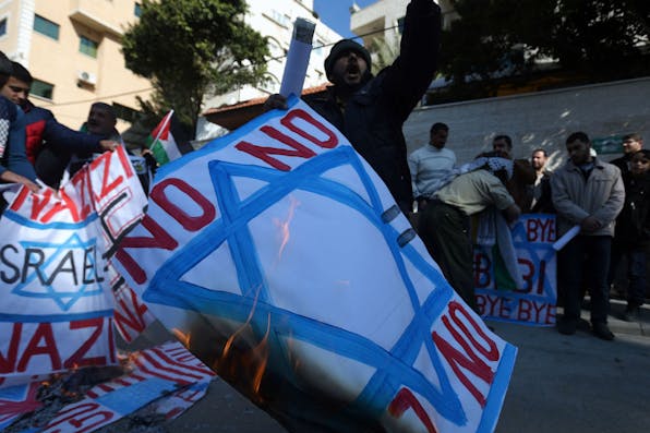 *Palestinians burning placards bearing the Israeli flag in 2016 in Gaza.* MOHAMMED ABED/AFP/Getty Images. Rejectionism