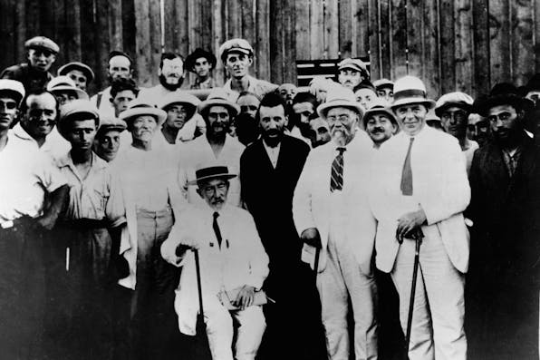 *Ahad Ha’am sits next to Rabbi Yabloner, right, head of the Naḥalat Yaakov ḥasidic colony in pre-state Israel, while visitors and other colony members gather around them.* Hulton-Deutsch Collection/CORBIS/Corbis via Getty Images. Haam