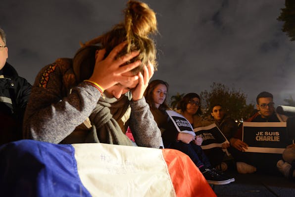 *A vigil in solidarity with the victims of the *Charlie Hebdo* shooting in January 2015.* *SAM YEH/AFP/Getty Images.* McClay-France-Main
