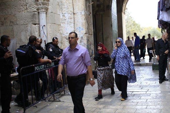 *Israeli police stand guard as Muslim worshippers walk to Friday prayer near the Al-Aqsa Mosque in Jerusalem on October 23, 2015.* Muammar Awad/Anadolu Agency/Getty Images. Pollock