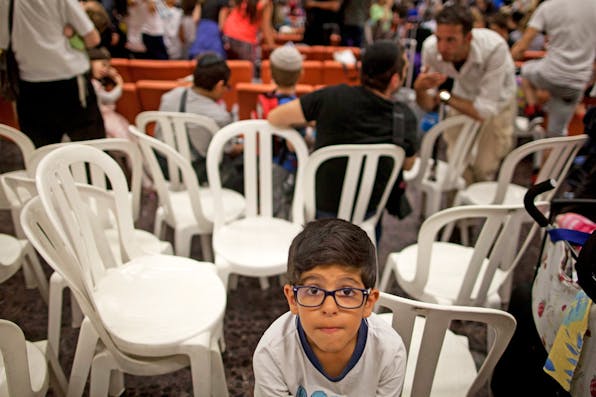 *A boy during a welcoming ceremony at Ben Gurion airport in Tel Aviv after arriving on a flight from France on July 16, 2014. *Photo by Lior Mizrahi/Getty Images. Wisse-Response-France