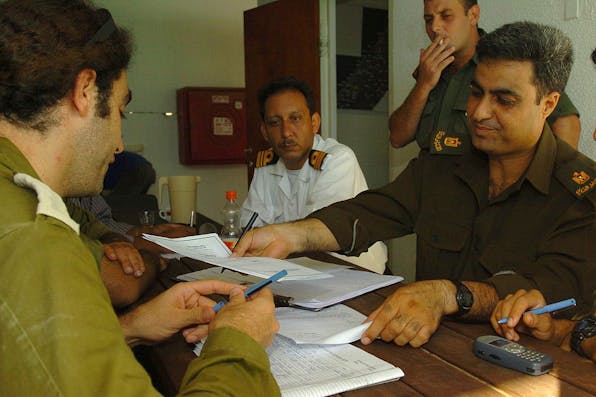 *Israeli and Palestinian officers hold a field situation assessment in preparation for Israel’s 2005 Gaza disengagement.* IDF. Lord-Main