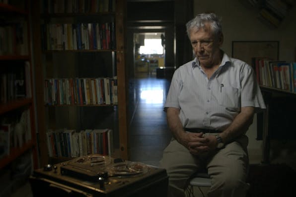 *Amos Oz listens to testimony he gave after the Six-Day War, in which he fought. *Photo by Avner Shahaf. censoredvoices