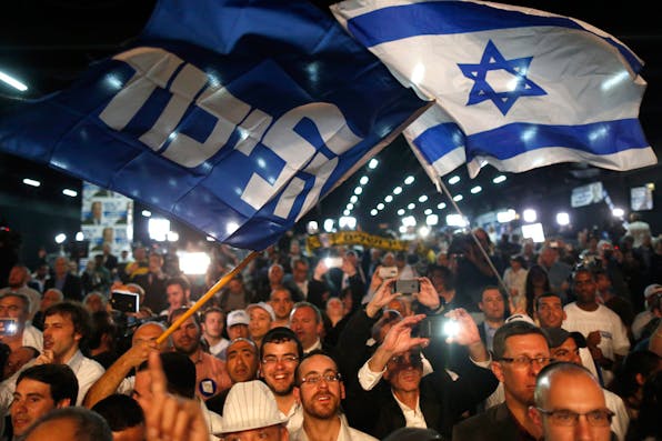 *Israelis at an election rally in Tel Aviv in 2015.* ABIR SULTAN/epa/Corbis. Roga-Main