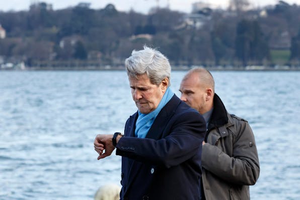 *U.S. Secretary of State John Kerry checks his watch as he walks to a meeting with Iranian Foreign Minister Mohammad Javad Zarif in Geneva, Switzerland, Sunday, Feb. 22, 2015.* AP Photo/Keystone,Salvatore Di Nolfi. Kerry-Main-Home
