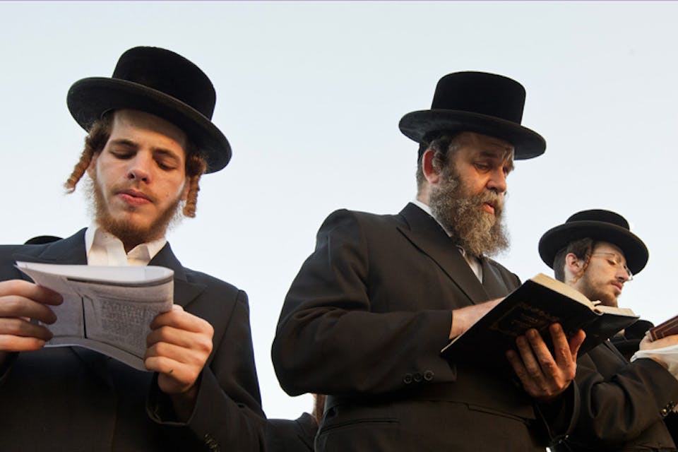 *Ultra-Orthodox men praying in Ramat Gan, Israel*. Photo by Ahikam Seri/Bloomberg via Getty Images. Koppel-Main