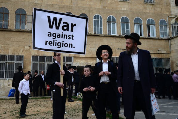 Haredi *Jews protest a military draft bill on March 2, 2014 in Jerusalem.* Photo by Salih Zeki Fazlioglu/Anadolu Agency/Getty Images. BerkoHomeandMain