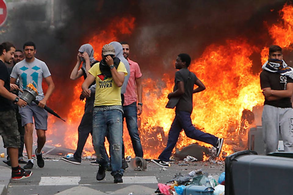 *Rioters, some of whom burned several Jewish-owned stores, face police in a Paris suburb on July 20, 2014.* AP Photo/Thibault Camus Gurfinkiel-Response