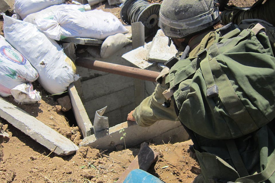 *An IDF soldier peers into a Hamas tunnel in the Gaza Strip in July 2014.* Photo by the IDF Spokesman Unit. idf_soldiers_found_terror_tunnel_in_gaza_14753333031