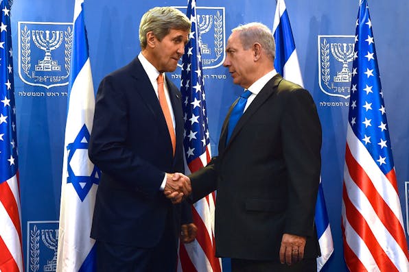 *U.S. Secretary of State John Kerry shakes hands with Israeli Prime Minister Benjamin Netanyahu in Tel Aviv on July 23, 2014, before the two sat down to discuss a possible cease-fire to stop Israel's fight with Hamas in the Gaza Strip.* Photo by the U.S. Department of State. john_kerry_and_benjamin_netanyahu_july_2014