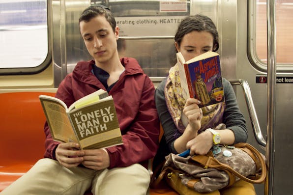 *A Modern Orthodox boy reads Joseph B. Soloveitchik’s *The Lonely Man of Faith* on the New York City subway.* Photo courtesy Ourit Ben-Haim. lonelymanoffaithsubway85