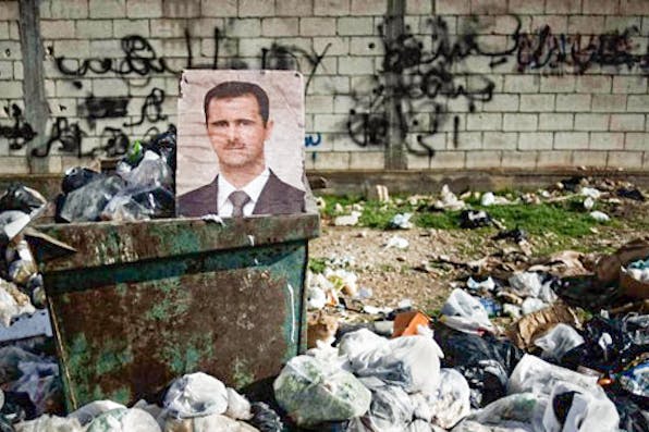 *A photo of the Syrian president Bashar al-Assad.* Courtesy FreedomHouse/Flickr. assadtrash