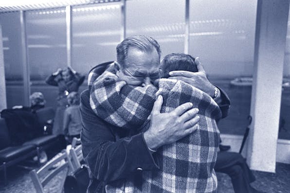 *A Jewish woman, just arrived from Russia, sees her brother for the first time in twenty years at Lod Airport, November 15, 1972.* Moshe Milner/Government Press Office (Israel). reunionblue27