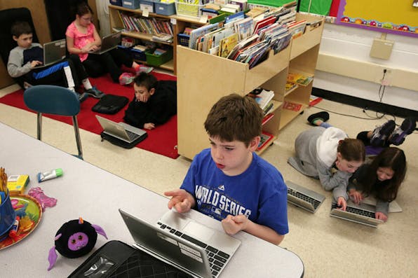 Seth Erdman, center, and his fellow students use Chromebooks while working on a lesson in a third grade class on Friday, Jan. 16, 2015, at Walden Elementary School in Deerfield, Ill. (Anthony Souffle/Chicago Tribune/Tribune News Service via Getty Images)